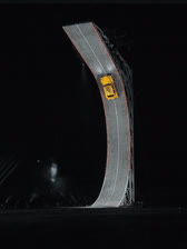 Animated scene preview: a yellow car drives off a tall ramp and lands in smoke.